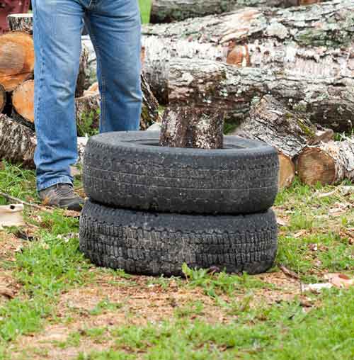 technique to use bolted tires to hold firewood when splitting by axe - steve maxwell