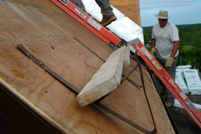 asphalt shingles bare roof deck with roof jacks